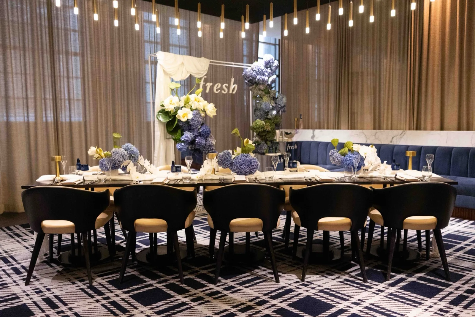 Corporate brand dinner in Sydney styled with blue hydrangea centrepieces and hanging pendant lighting