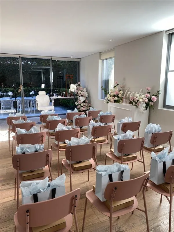Fresh brand event seating styled with gift bags and floral installations