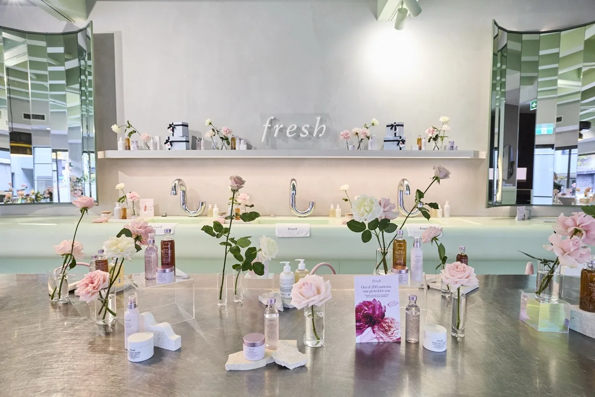 Fresh brand activation styled with fresh roses and skincare product display
